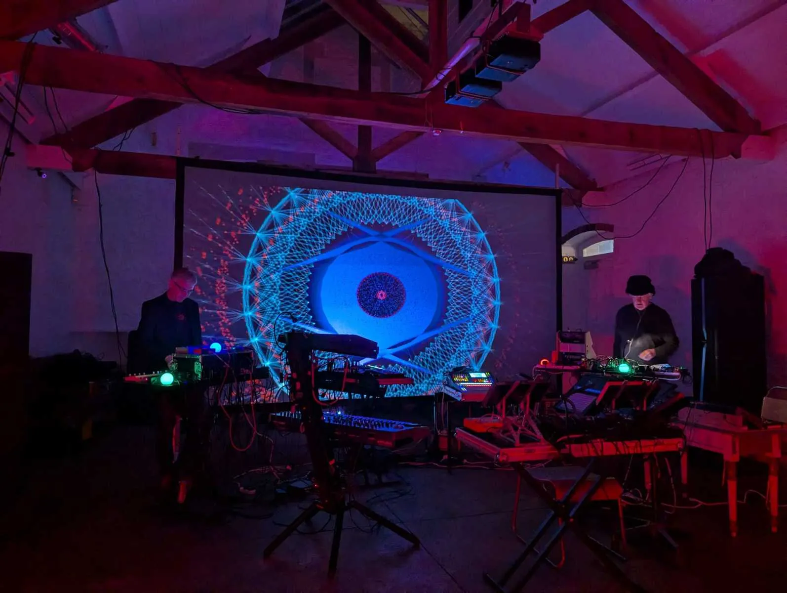 Andrew Sloan and Andrew Shackleton performing at the Silk Mill, Frome, in front of a projected geometric image. Photograph by Nik Bartlett.